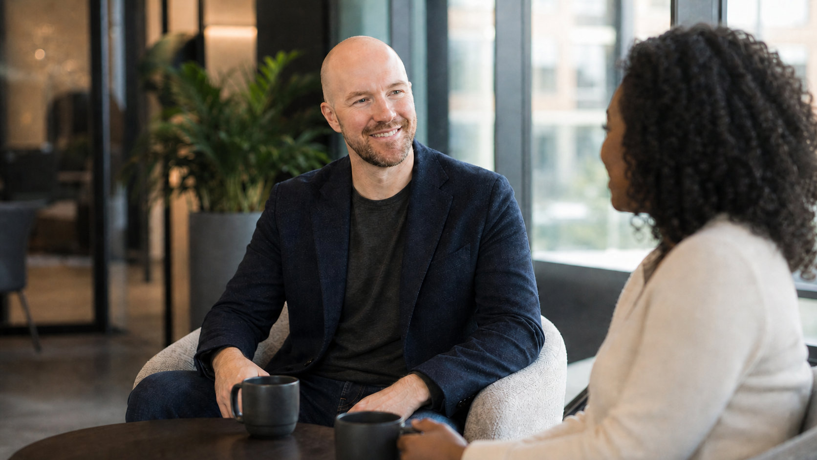 Julian Murphy talking with a colleague in a bright office