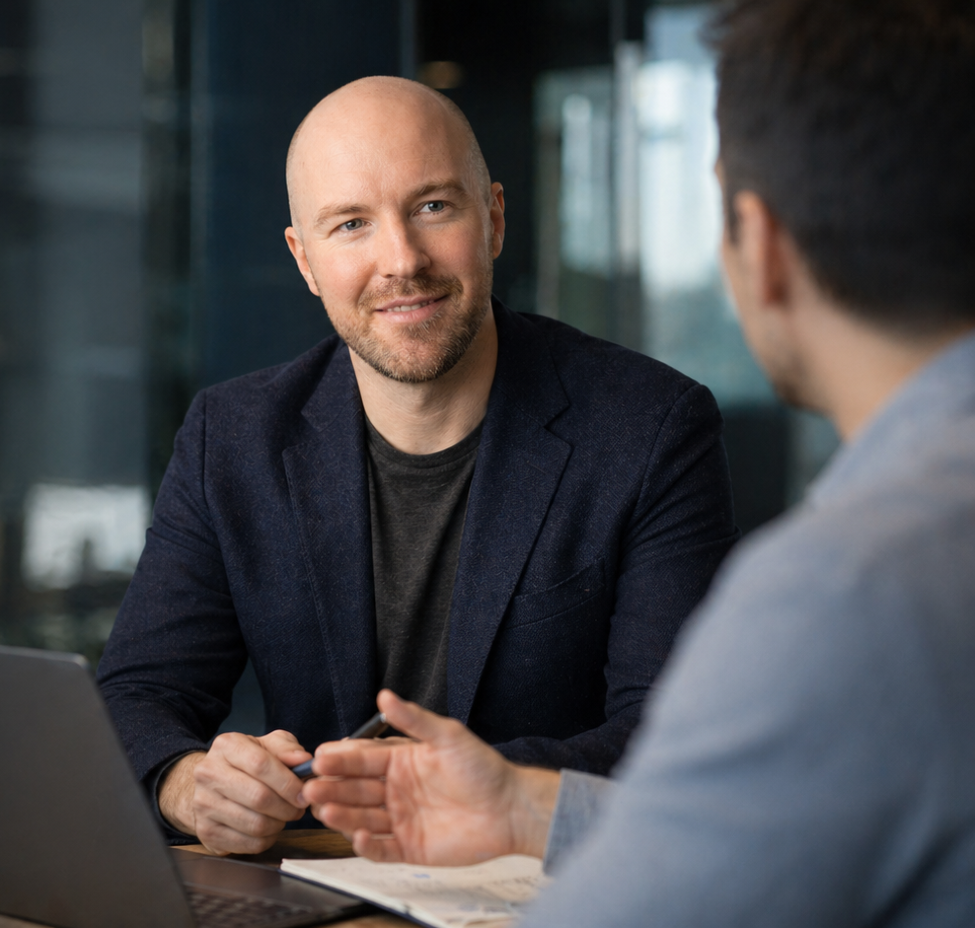 Julian Murphy talking with a colleague in a bright office