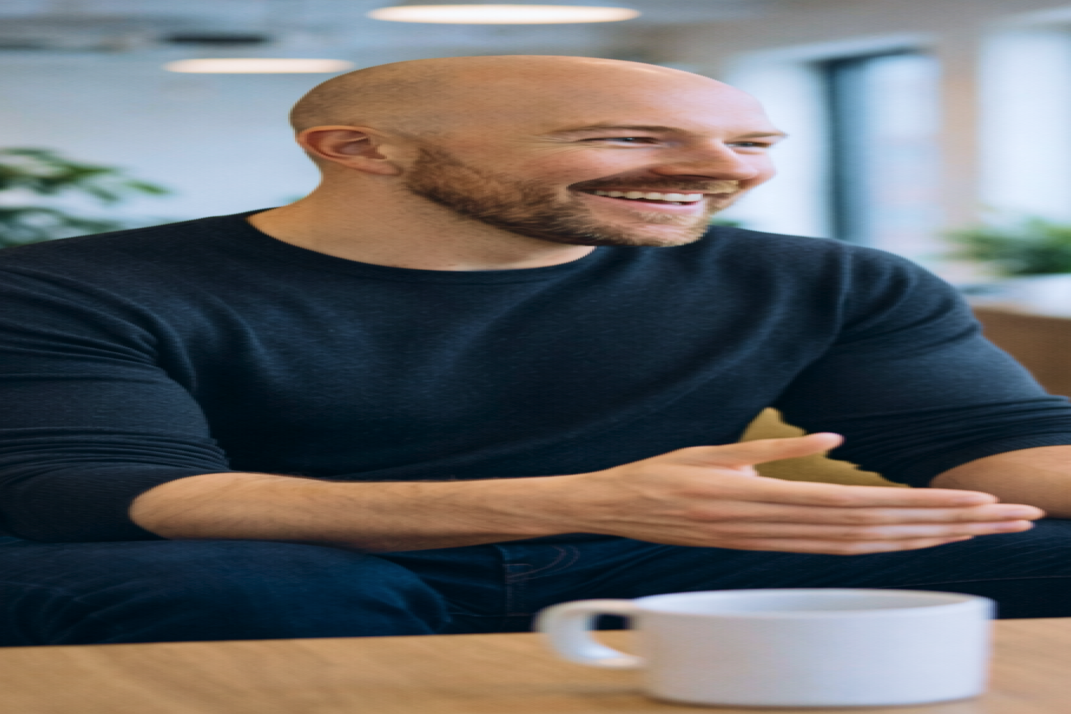 Julian Murphy talking with a colleague in a bright office